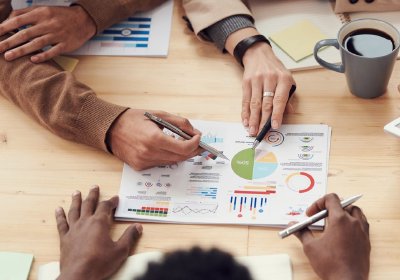 Small team discussing financial documents at a table